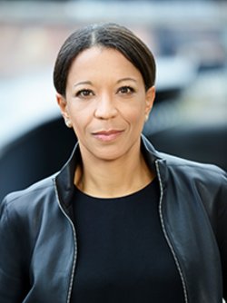 janina-kugel wearing a black leather jacket and smiling