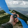 Hand with compass in the mountains