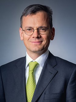 dominik asam with glasses and smiling