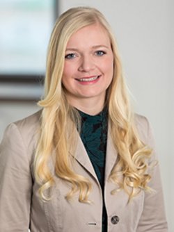 katharina schwarz wearing brown blazer and smiling