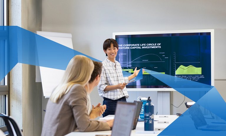 Female asian FIM student presents something to her fellow students via powerpoint
