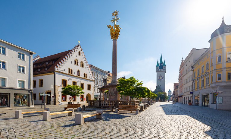 A city square with benches and shops around it