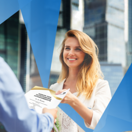 A smiling young woman presents a man with a certificate of honor for outstanding achievement