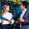 Female and male business colleagues inspecting internet database servers at computer security