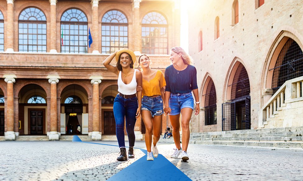 Group of students taking a selfie infront of the Tower Bridge in London . They are three girls and two boys, embracing and having fun together.