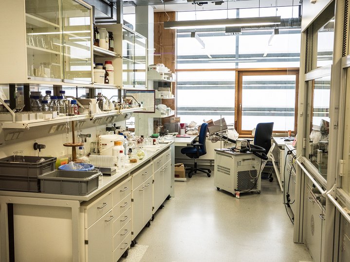 Lab with different equipment like tubes on the white table with two chairs