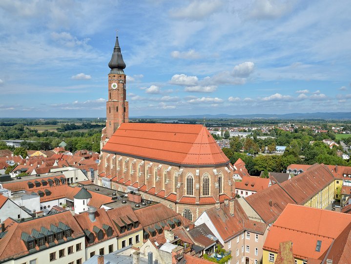 An aerial view under the sky with tall building and red roof