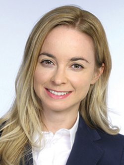 Headshot of a female student with blonde long hair smiling at the camera.