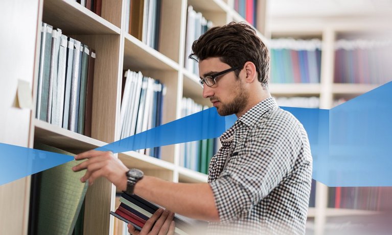 A boy looking for a book in library 