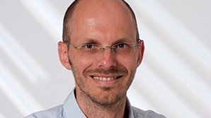 Headshot of Prof. Dr. Helmut Farbmacher , a middle age man smiling on a simple white  background.
