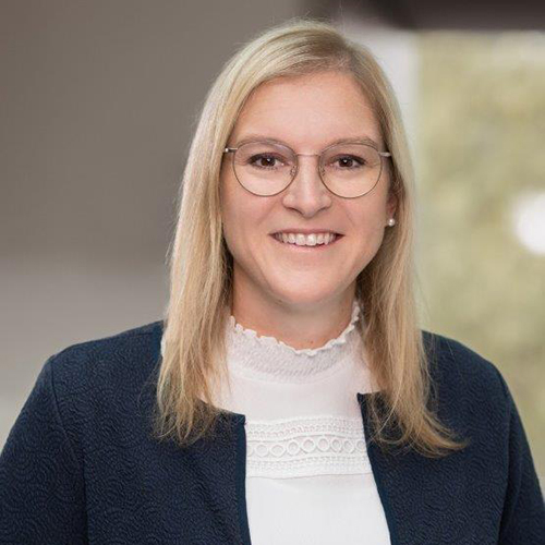 Blond woman with glasses smiling