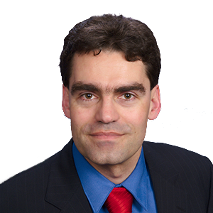 Headshot of Prof. Dr. Tim Büthe, a middle age man smiling on a simple white  background.