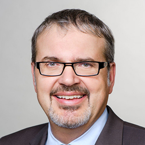 Prof. Dr. Headshot of Prof. Dr.  Christoph Kaserer, a middle age man smiling on a simple white background.