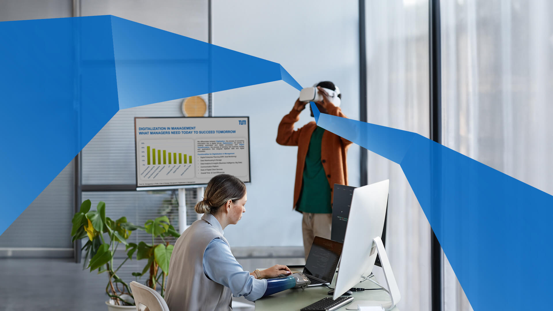Man with VR headset and woman at a computer
